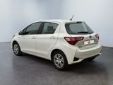 the rear end of a white toyota yaris parked in a room