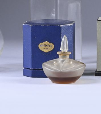 a bottle of perfume next to a box of perfume