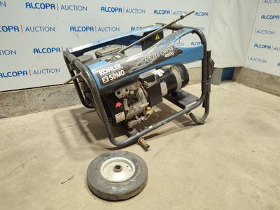 a small generator on the ground in front of a wall