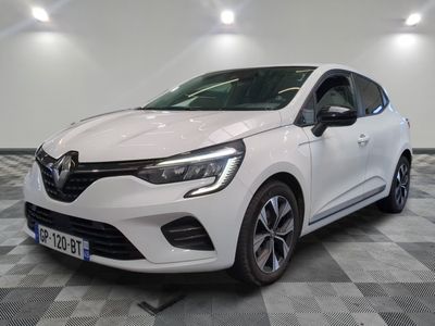 the white car is parked on a checkered floor in a garage