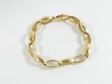 a close up of a gold bracelet on a white surface
