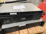 a stack of servers sitting on a pallet in a warehouse