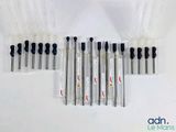 several different types of pens are lined up on a white surface