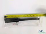 someone is measuring the length of a piece of plastic with a ruler