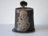 a small pot with a plant in it on a table