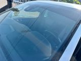 a close up of a car ' s windshield with a dog in the back seat