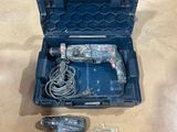 an image of a corded drill and two batteries in a case