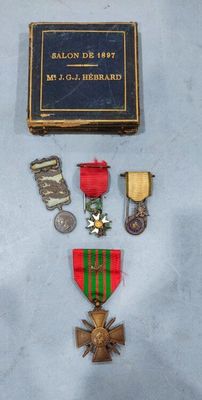 an assortment of medals including a medal, a medal, and a book