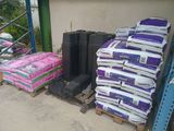 a pile of bags of cement on a pallet next to a pile of bags of cement