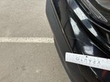 a sticker on the front of a car that is parked on the side of the road