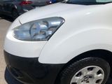 a white van parked in a parking lot with other cars in the background