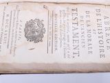 an old book that is open on a table