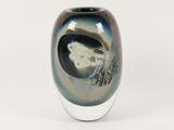 a black and white vase sitting on a white surface