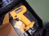 a yellow cordless drill in a box with other tools
