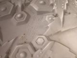 a close up of a white vase with a star design on it