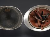 an old silver cup with a brown leather lid and a silver cup with a brown leather lid