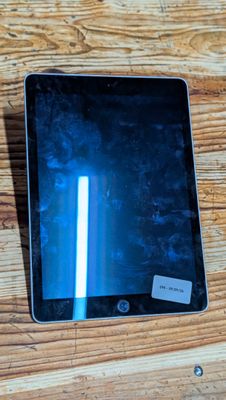 a tablet that is sitting on a wooden table