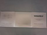 a white booklet with black writing on it on a table