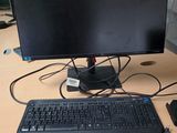 an image of a computer desk with a keyboard, mouse, and monitor