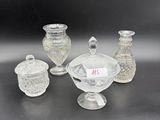 a group of glass vases and jars sitting on a table