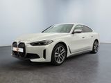 a white bmw car is parked in a large room