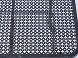 a black metal table with a white and black pattern on it