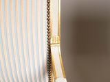 an image of a chair with a striped upholstered back and arms