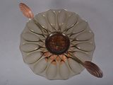 a white plate with a brown flower on it