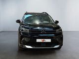 the front view of a black suv parked in a room