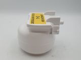a close up of a white object with a yellow label on it