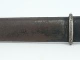 a knife that is laying on a white surface