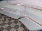 two empty shelves in the corner of a store