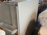 a refrigerator that is sitting in a room with many boxes