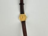 a close up of a watch on a white surface