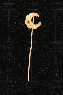 a yellow flower on a black tile floor with a black background