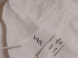 the back of a white shirt with a tag on it