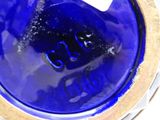 a close up of a blue vase with a number on it