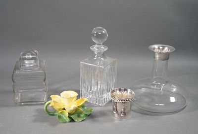 three glass vases and a silver vase on a table