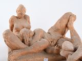 a statue of two people laying on a couch