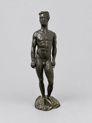 a bronze statue of a man standing on a rock