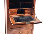 a small desk with a marble top and drawers