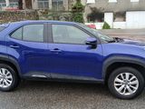 a blue toyota rav parked on the side of the road