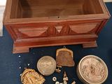 a small wooden chest with a lot of things inside of it