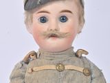 a small doll with a moustache on it ' s face