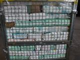 a cart full of toilet paper sitting in a warehouse