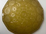 a picture of a yellow plate on a white wall