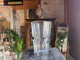 a glass vase sitting on a table in a room