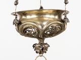 a large metal hanging bowl with a ring on it