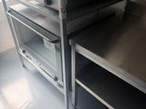 a silver oven sitting on top of a metal counter