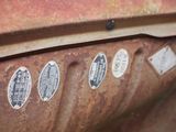 many stickers on the side of a rusted truck